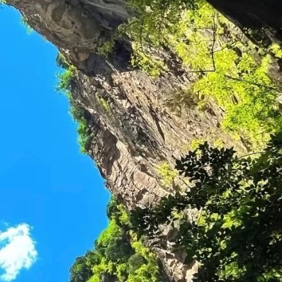 抬头穿过山岩的缝隙，撞见一整片澄澈蓝天。大山静默伫立，接纳风雨，也盛放阳光，世间