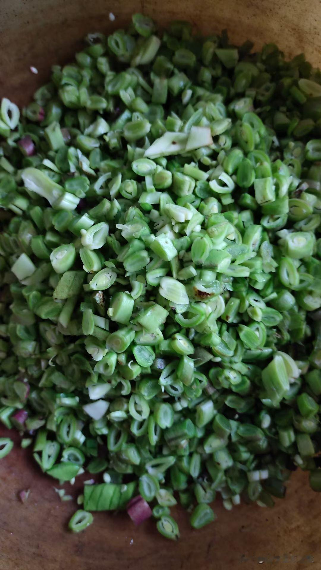 【墨盘好物：芸豆菜饼】切好的芸豆放铁锅里剁。我妈妈我姐姐就是这个手法！
接着炒馅