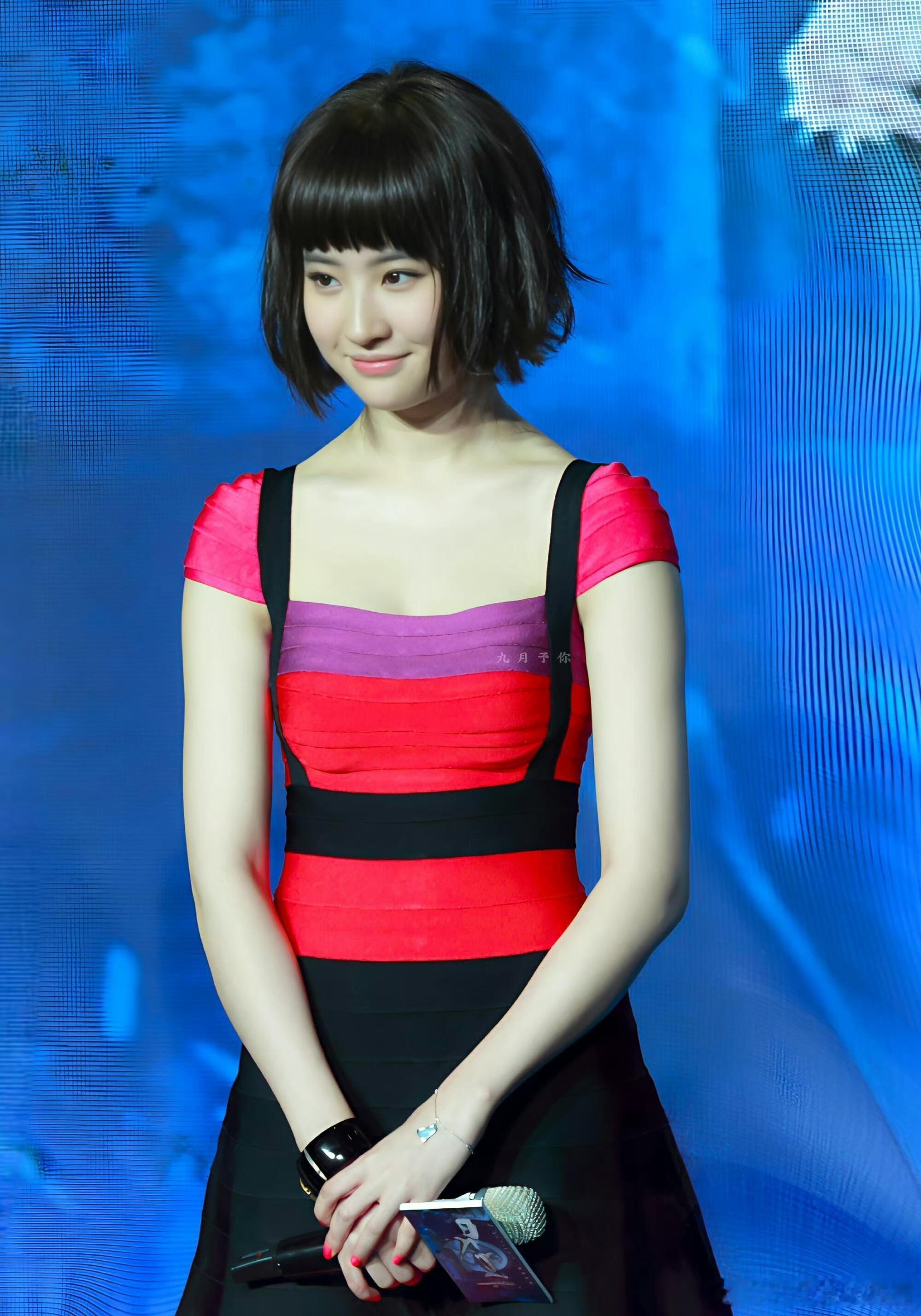 刘亦菲这次身着的撞色绷带裙，上半身以玫红、紫红、正红的条纹层层叠叠，搭配黑色宽肩