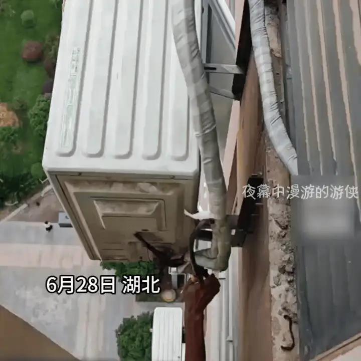 湖北，一安装师傅刚刚安装完一台空调，正在调试。突然看见下面伸出一只拿着钳子的手在