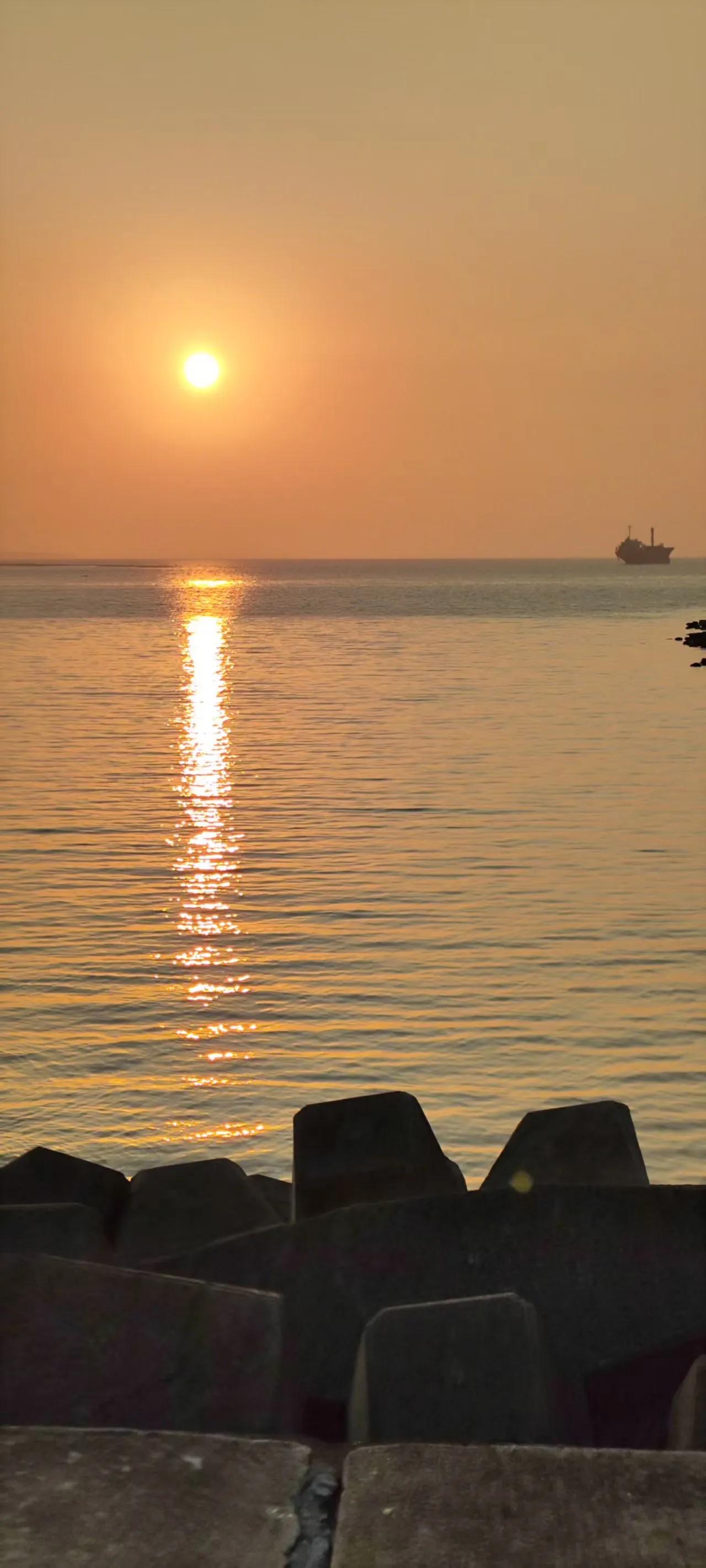 海上夕阳红，石上静观潮。