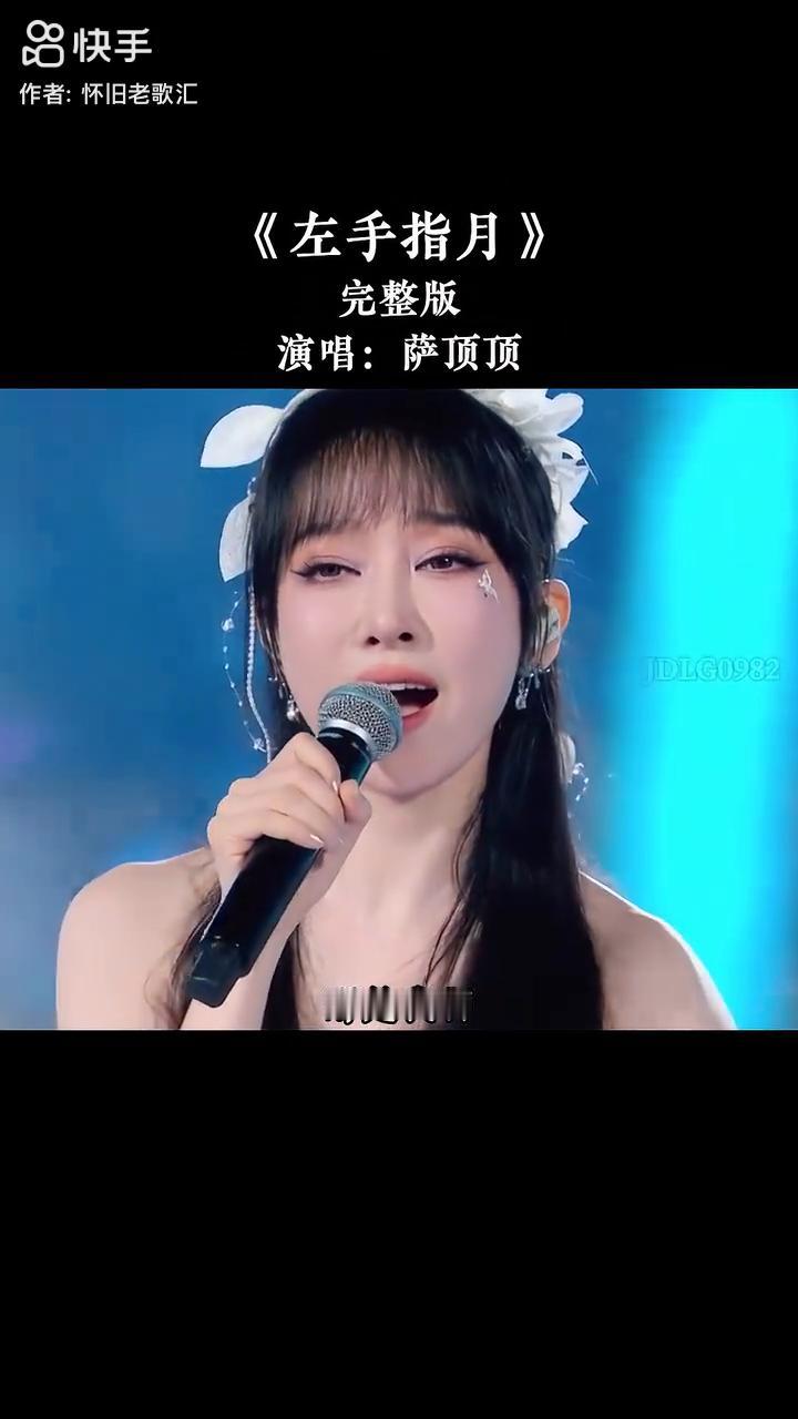 《左手指月》完整版，演唱：萨顶顶。
左手握大地，右手握着天。掌纹裂出了十方的闪电