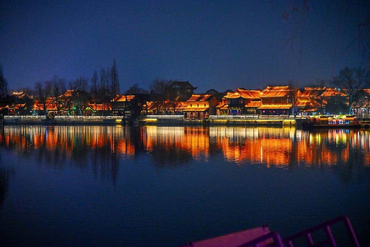 当夜幕漫过运河，台儿庄便换了一副灵魂。
白日里的青砖灰瓦，此刻被光影染成琥珀色。