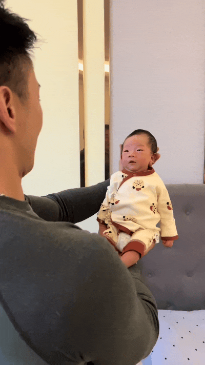 家人们谁懂啊！才出生10天的小奶娃，被爸爸捧在手里，居然直接笑开了花，真的太治愈