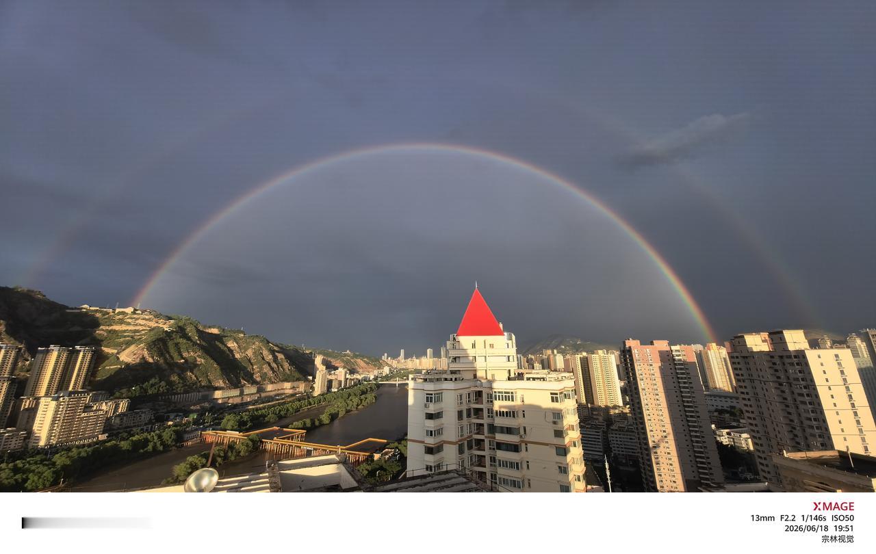 傍晚的阵雨匆匆掠过金城，乌云还未完全散去，一道完整的彩虹便横跨南北两山，温柔笼住