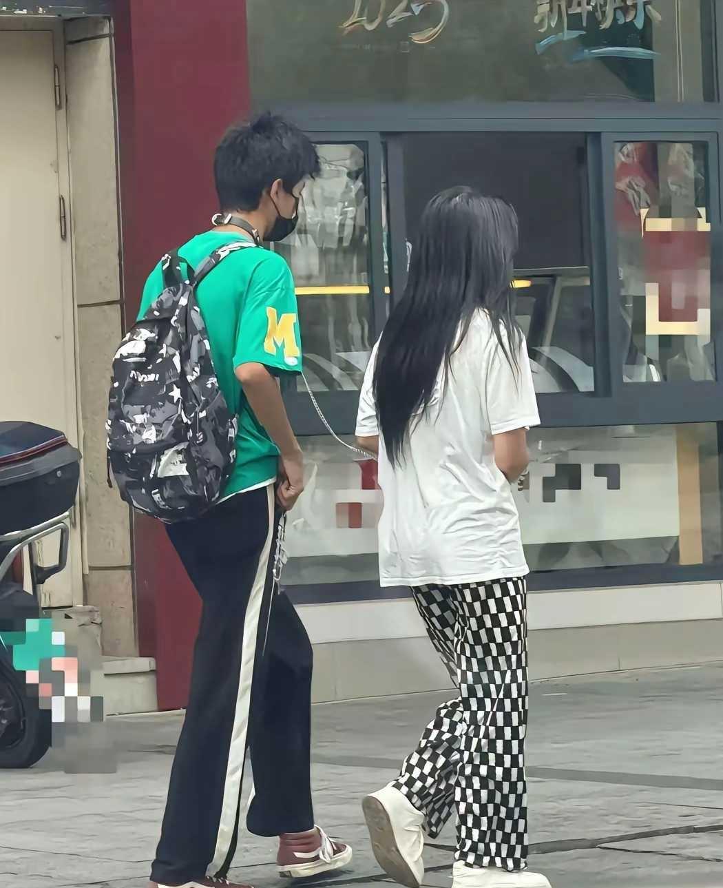 男孩脖子栓个铁链子让女孩牵着，看起来就和遛狗一样的，这到底是什么骚操作？有人说这