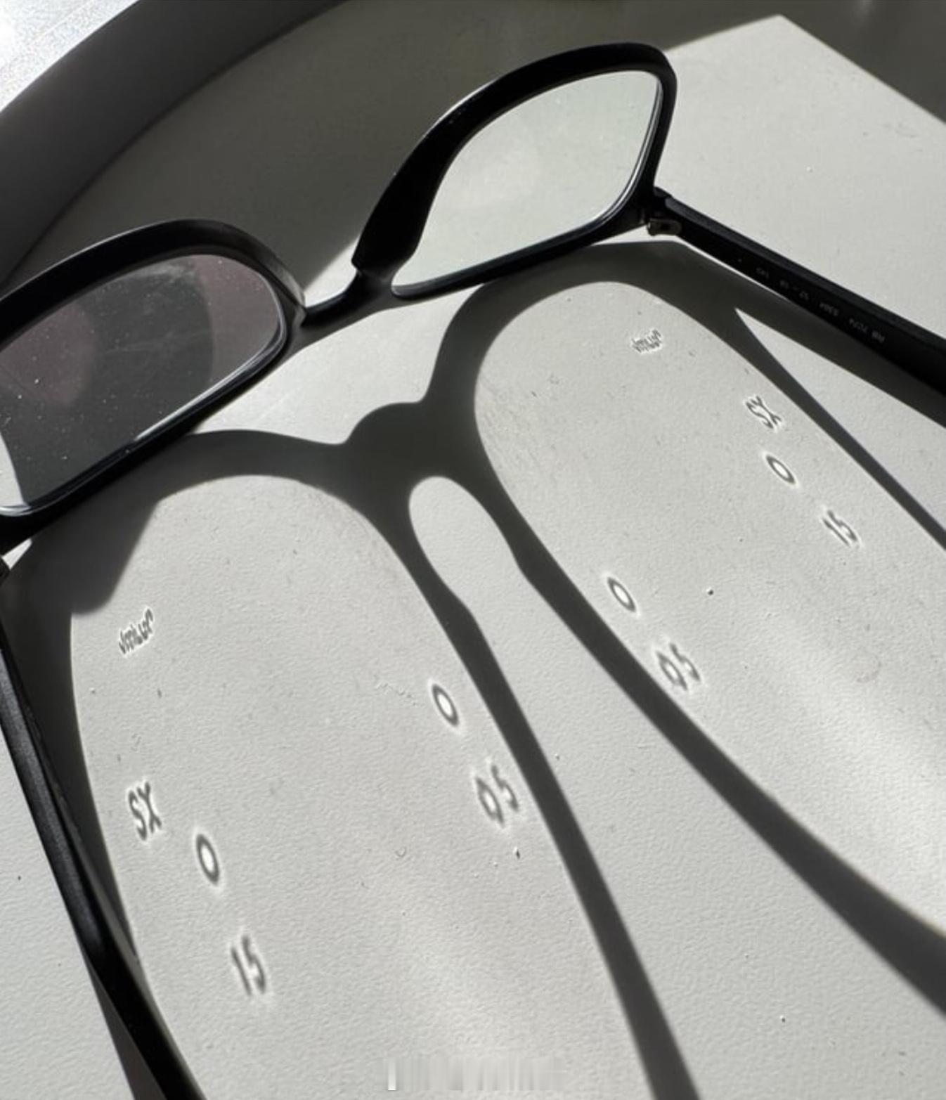 有些矫正视力镜片在光线以低角度照射时会投下激光蚀刻的参考标记。眼镜 光学 医学科