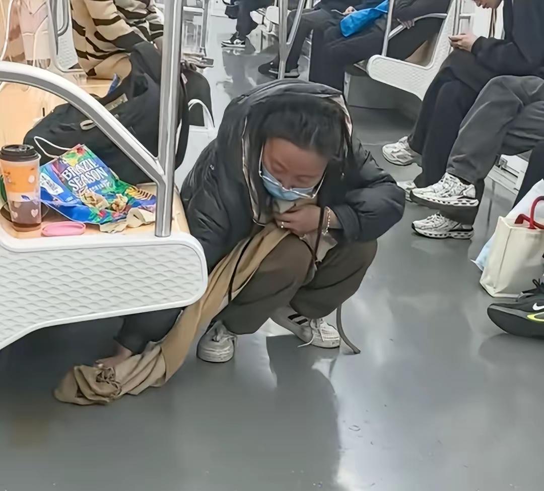 地铁上这一幕太戳心！姑娘饮料撒了没带纸，二话不说蹲下身，用自己的围脖默默擦去水渍