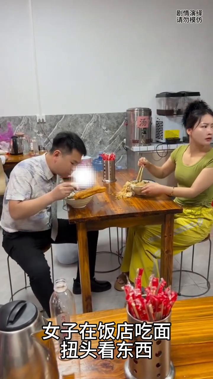 男子悄悄吃掉女子掉桌上的卤蛋。
女子在饭店吃面，扭头看东西，谁知下一秒她面里的卤