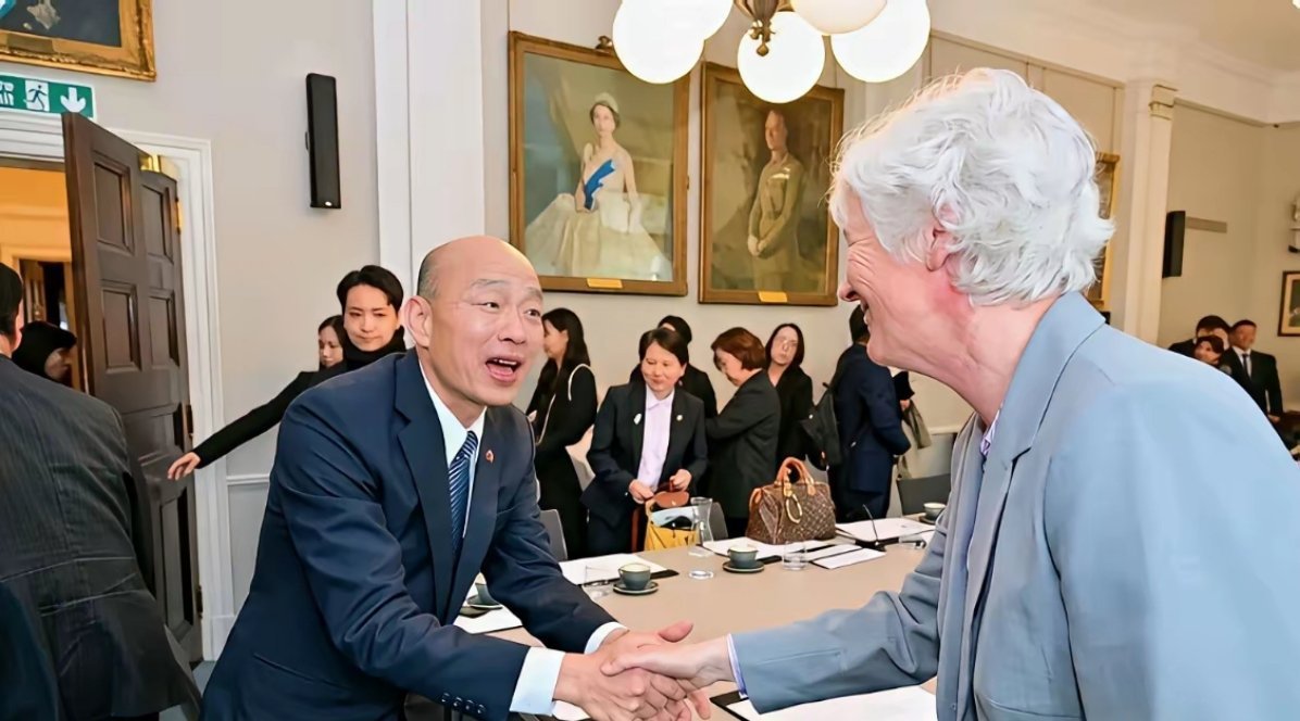 韩国瑜与英国议员握手时，腰弯九十度，大笑示好，双手捧住对方的手。 