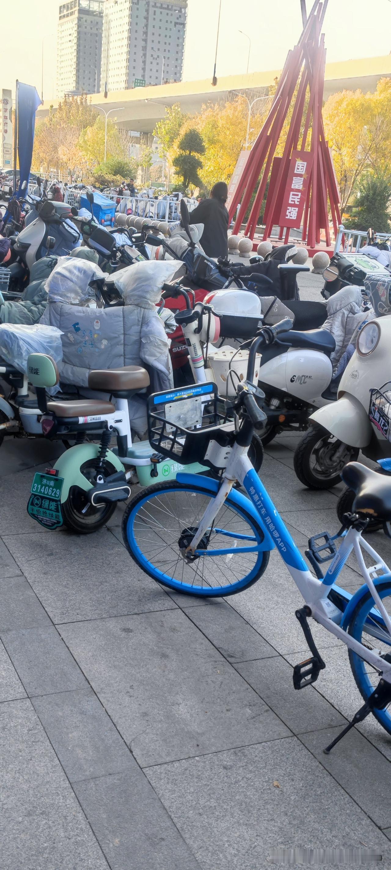 在商场的电动车停车点，
所有的电动车自行车都是一排一排的，顺着放的。

一个二十