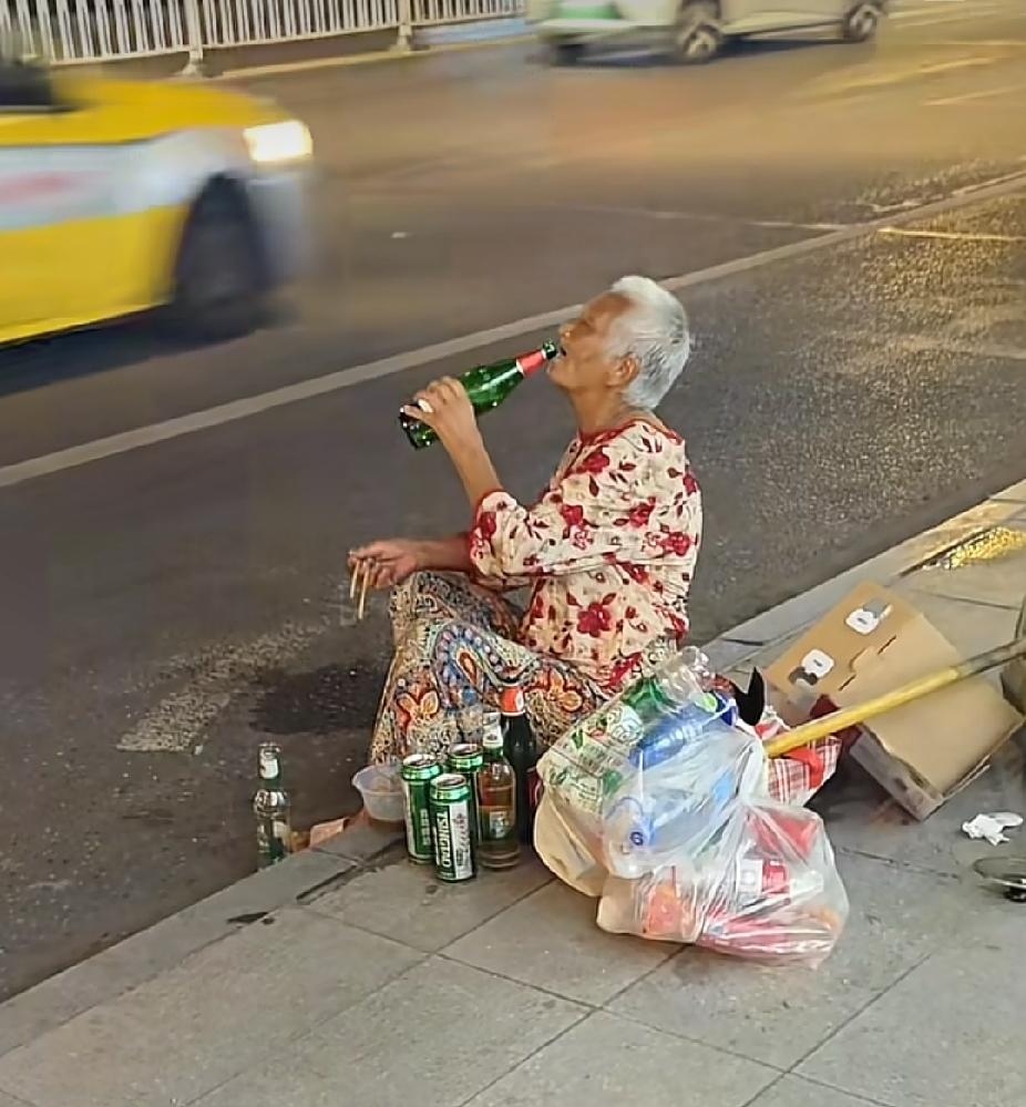 深夜时分，街边的路灯下，一位白发老人举瓶独饮的画面，看着让人五味杂陈了。

已是