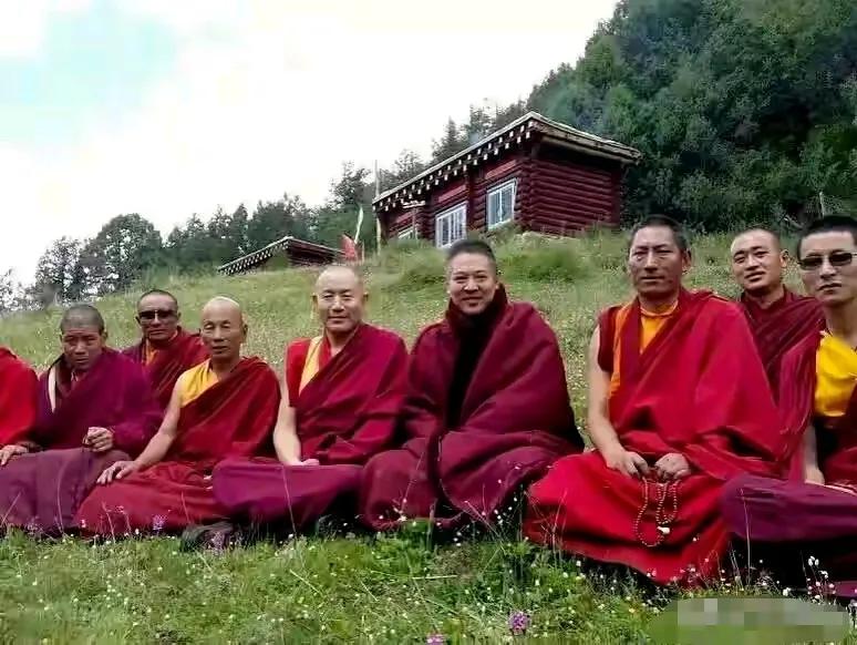 李连杰与和尚合影画面挺好看的，绿草如茵，衬得袈裟特别的养眼，养眼的还有李连杰那美