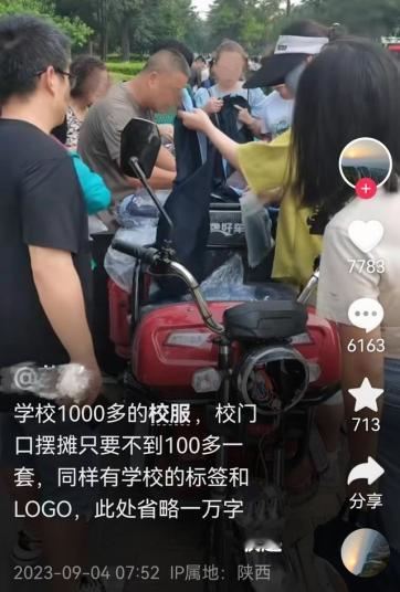 2023年9月4日，在陕西西安的一所中学的门口，一个男子卖学校同款的校服，而价格
