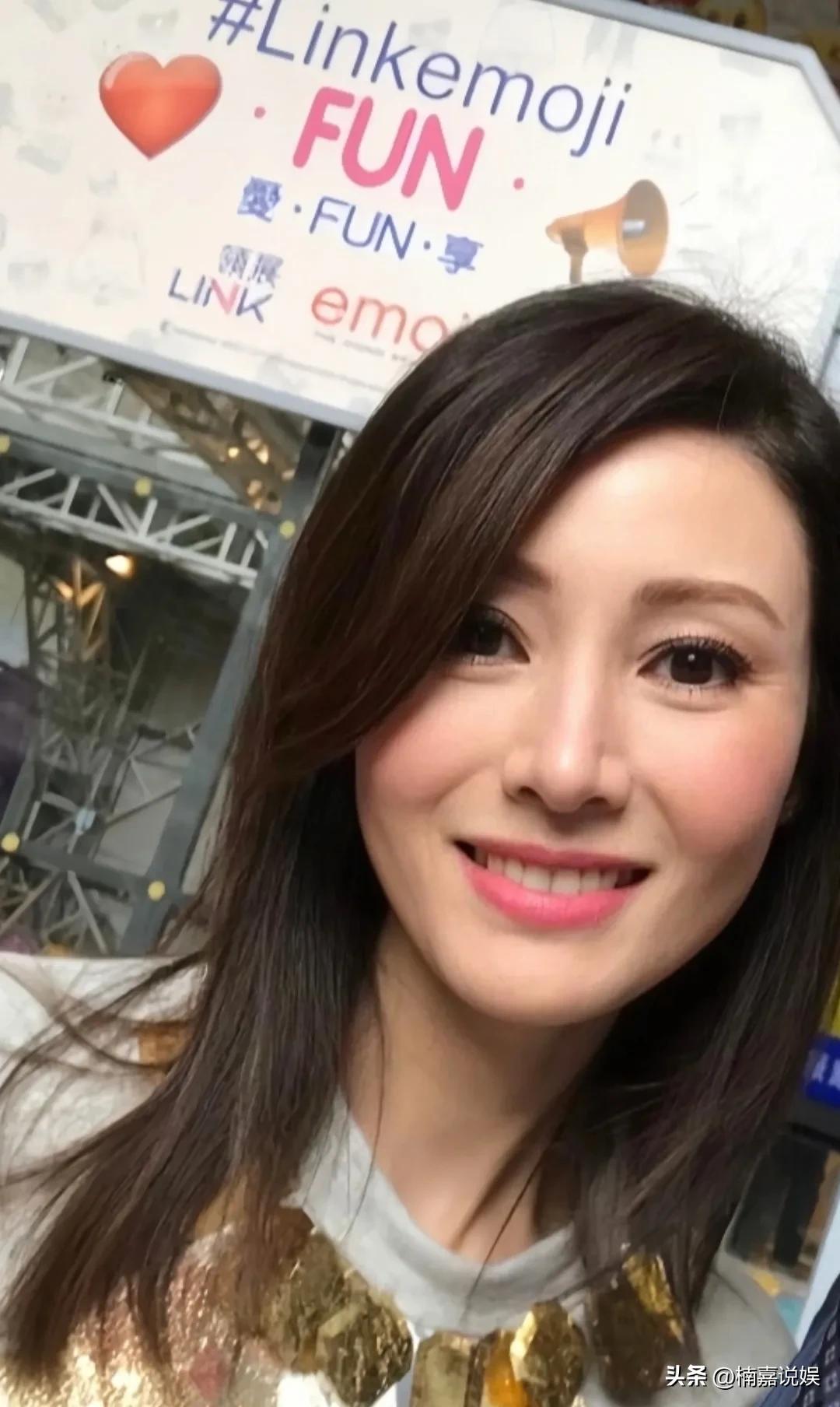 李嘉欣在香港出席活动，和主办方合影，原图直出，这颜值也太逆天了吧！
长发披肩的她