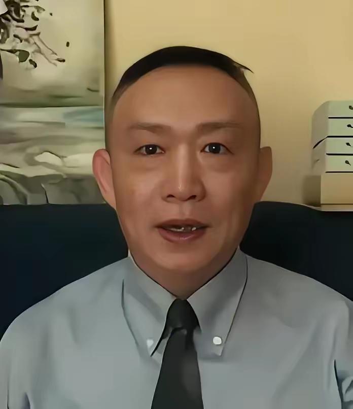 镜头里的卢麒元，穿着挺括的浅蓝衬衫配黑领带，坐在沙发前神情沉稳，眼神里透着一股剖