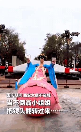 上人民日报了！
西安大唐不夜城，不倒翁小姐姐表演时，竟然把游客手机接了过去，将镜
