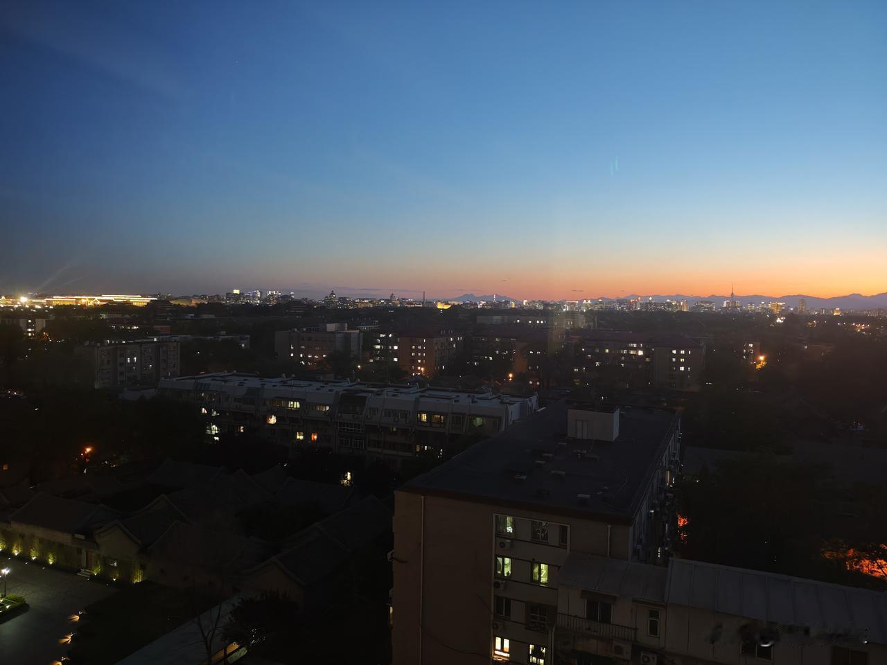 已经晚上7点半了 ，夜幕已经落下，夕阳还留有一抹光亮。远处天边泛黄的光色铺满了地