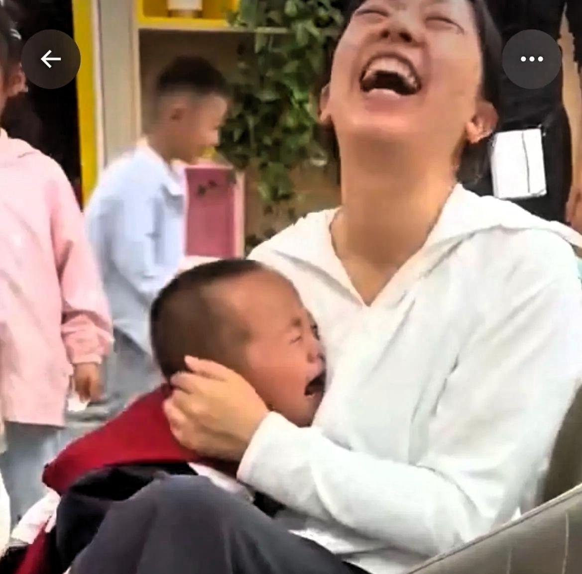 这是一段视频中的其中一张截图，一个三四岁的小朋友，委屈的在一个女人怀里哭，哭着哭