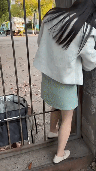 这个女孩顺着栅栏缝隙钻过去，难道不怕刮坏衣服吗？