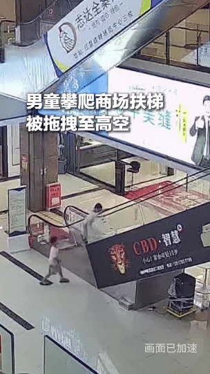 太惊险！江西上饶一名6岁男童贪玩攀爬商场扶梯，被运转的扶手带拖拽至6米高空悬空吊