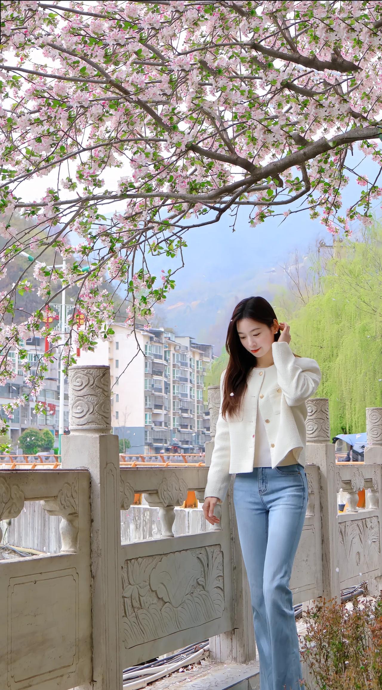 樱花树下，少女轻抚发梢，春意盎然。