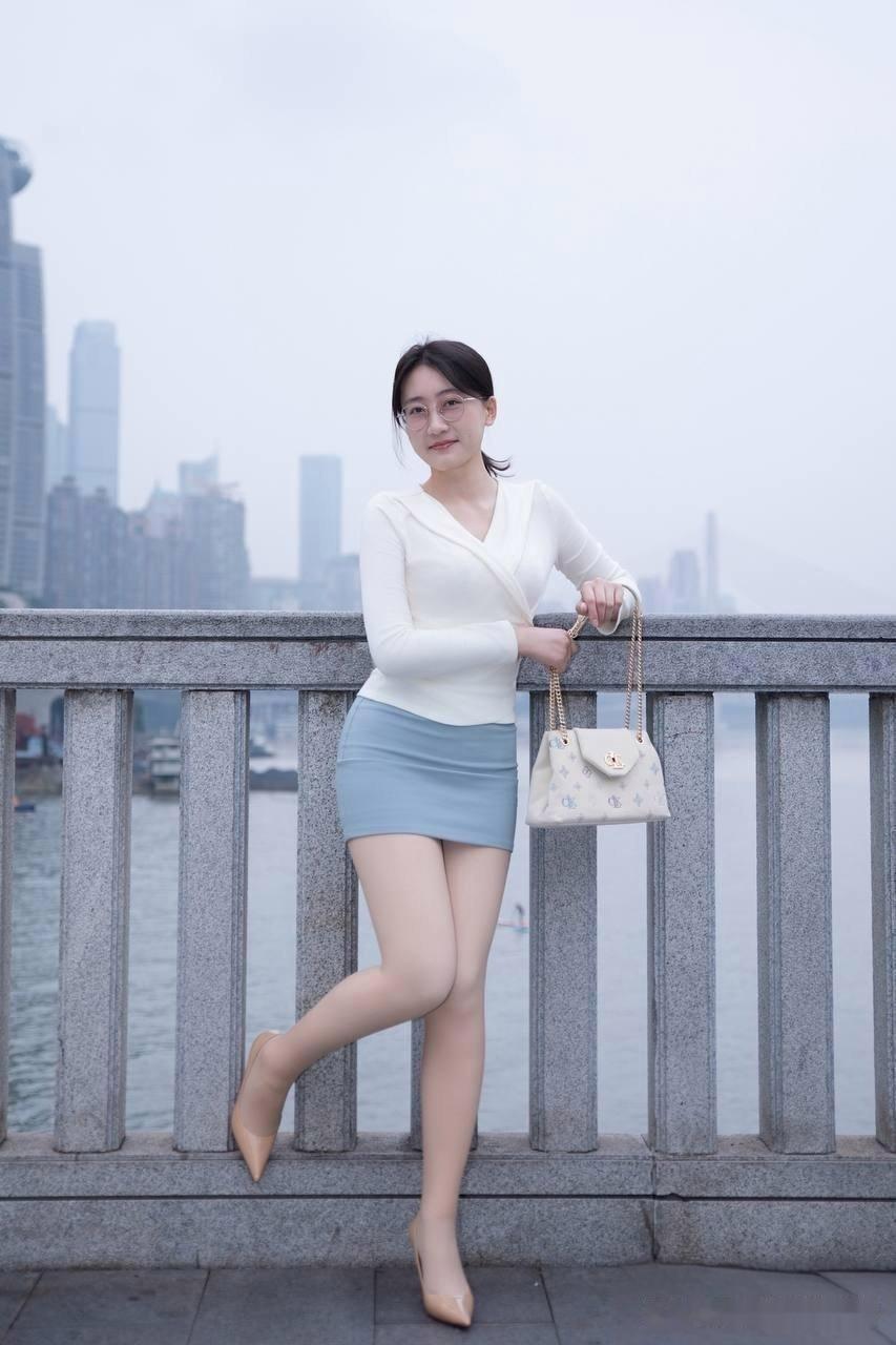 都市雅致风，优雅白裙与现代城市背景的完美融合。