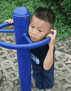 危险无处不在

小男孩在健身器材那里玩，他不小心钻到了健身器材的空隙里，他怎么也