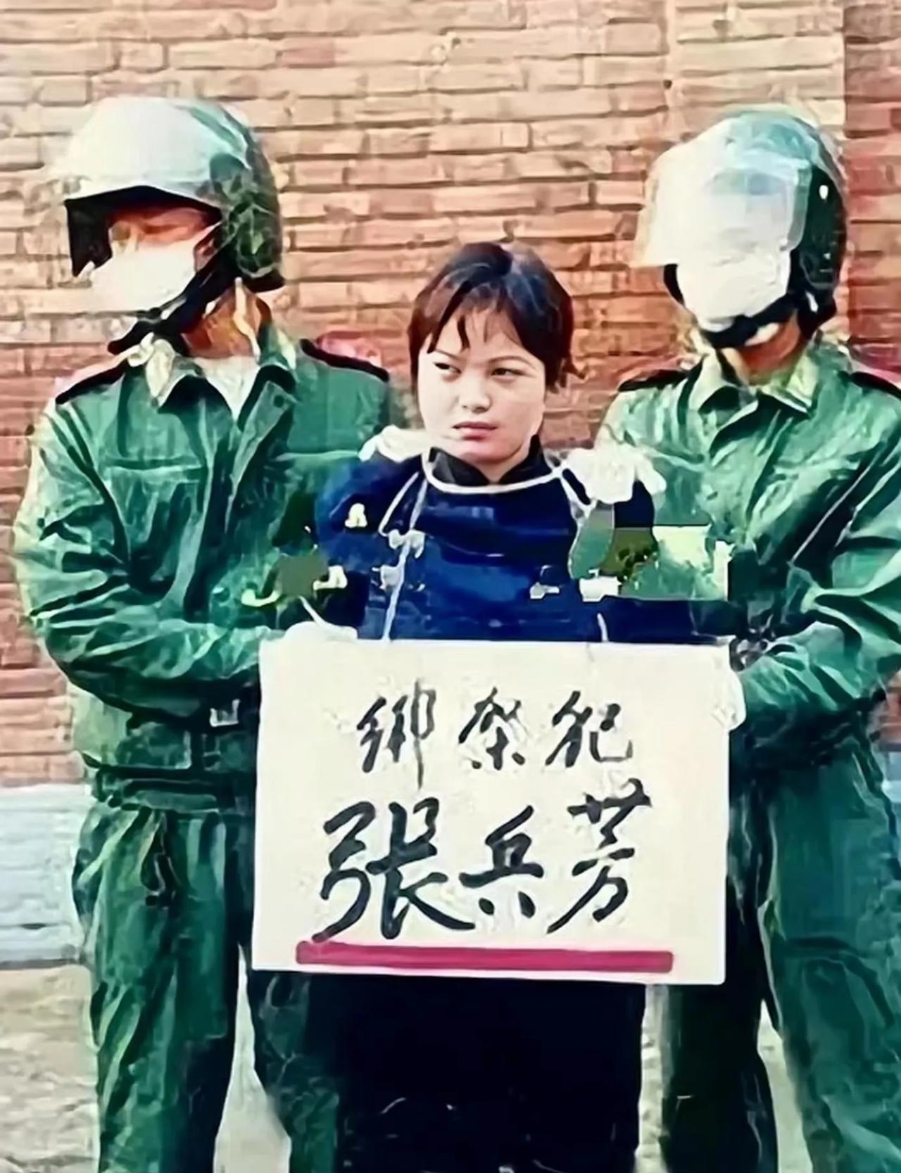 2002年，张兵芳被两名法警押着将执行枪决，脖子上牌子写着犯人张兵芳
 
 
 