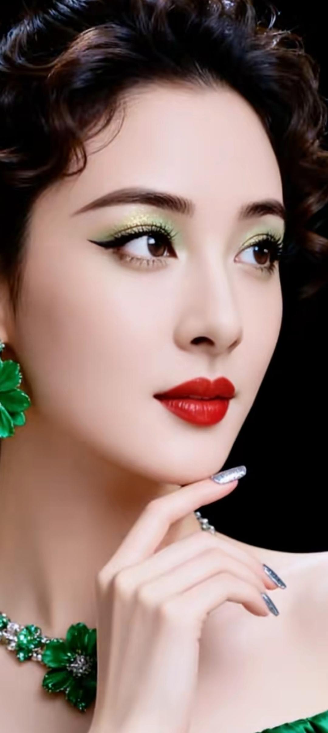 优雅红唇，复古妆容，绿宝石项链，尽显高贵气质。