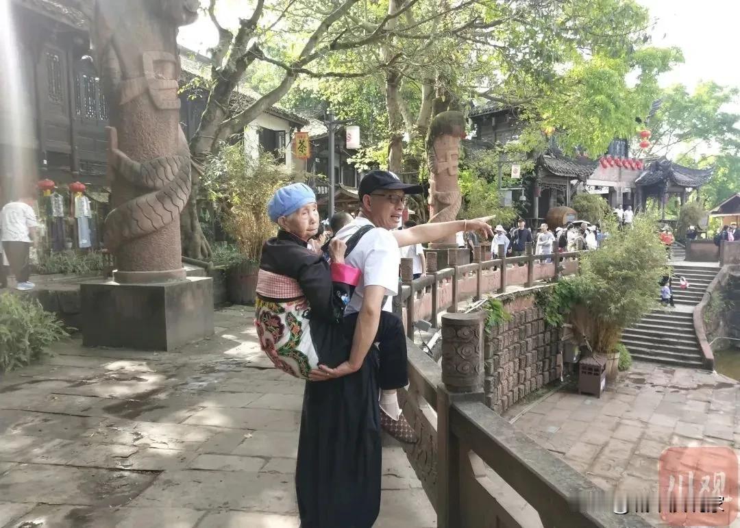 百善孝为先，还是看我大凉山！近日成都黄龙溪景区一位中年男子背老母亲旅游的视频火爆