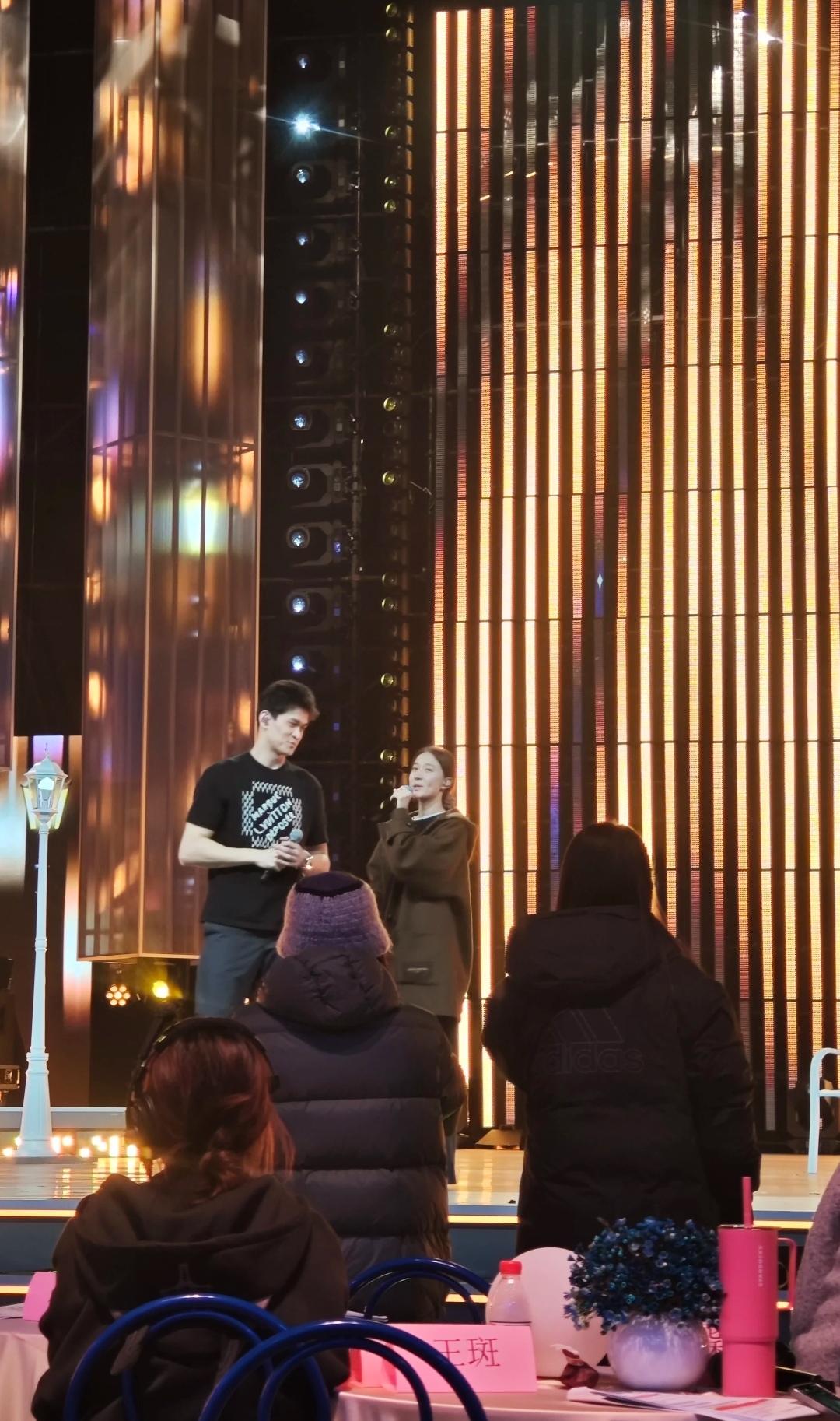 孙杨和妻子张豆豆现身北京一活动，小夫妻站在台上发言唱歌，台下坐满了认真听的观众。