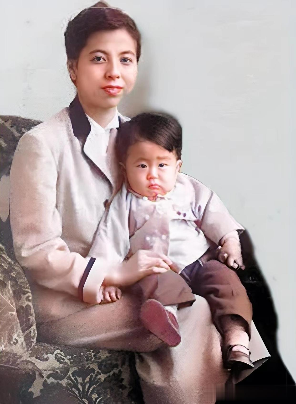 照片中的女子叫安倍洋子，而她怀中的孩子就是后来的日本首相安倍晋三，值得一提的是，