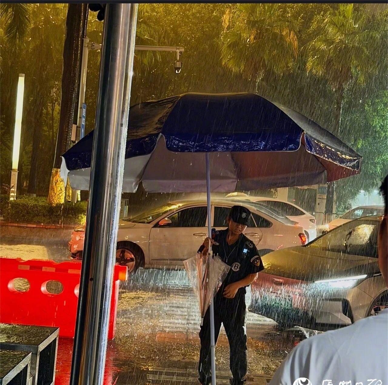 【大雨中保安扛巨伞多次往返护送旅客】6月15日晚，厦门北站出站口网约车上客区发生