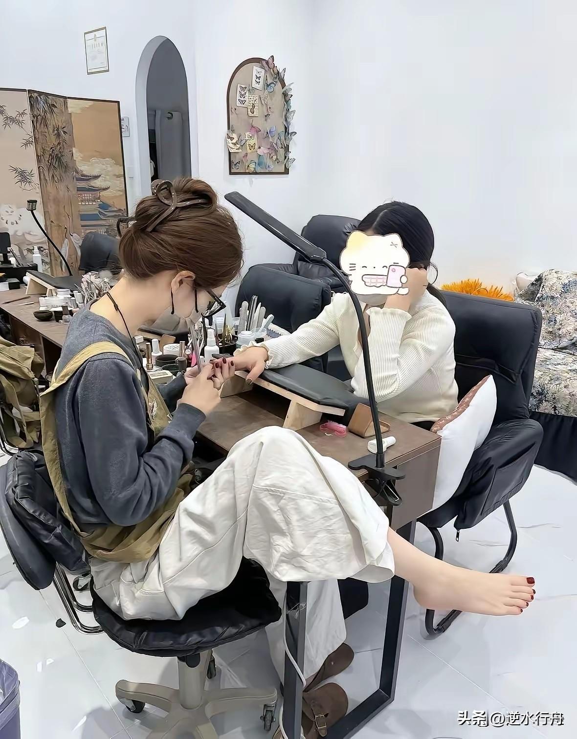 美甲师自己的脚就是最好的广告。路过这家美甲店见到这位美甲师正在帮客人做美甲，可能