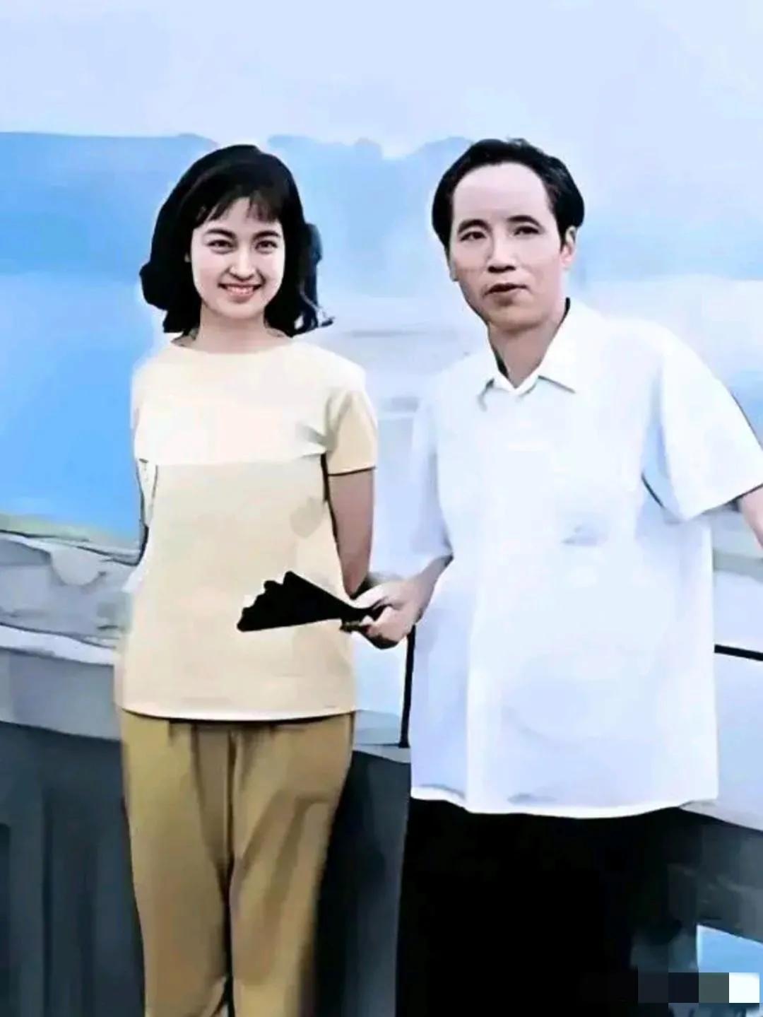 画面中的刘晓庆柔发覆额，龙眉凤目，樱唇贝齿，笑若暖阳，秀韵多姿；一旁拿着扇子的男