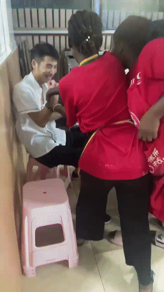 非洲加纳的一家中餐饭店里。
三名当地的黑人女服务员突然将一位中国厨师抬到了店门外
