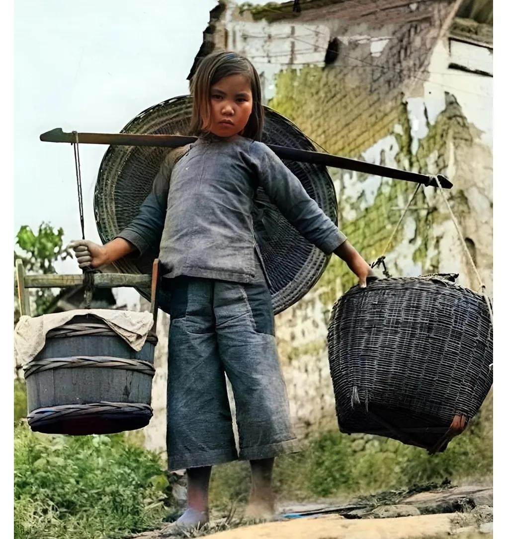 1944年，云南腾冲，一名小姑娘正挑着沉重的担子穿梭在石路上，仔细看会发现，这个