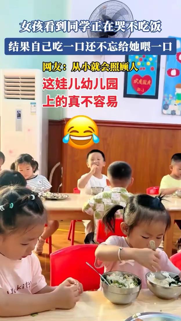 女孩看到同学正在哭不吃饭，结果自己吃一口还不忘给她喂一口。网友：从小就会照顾人，