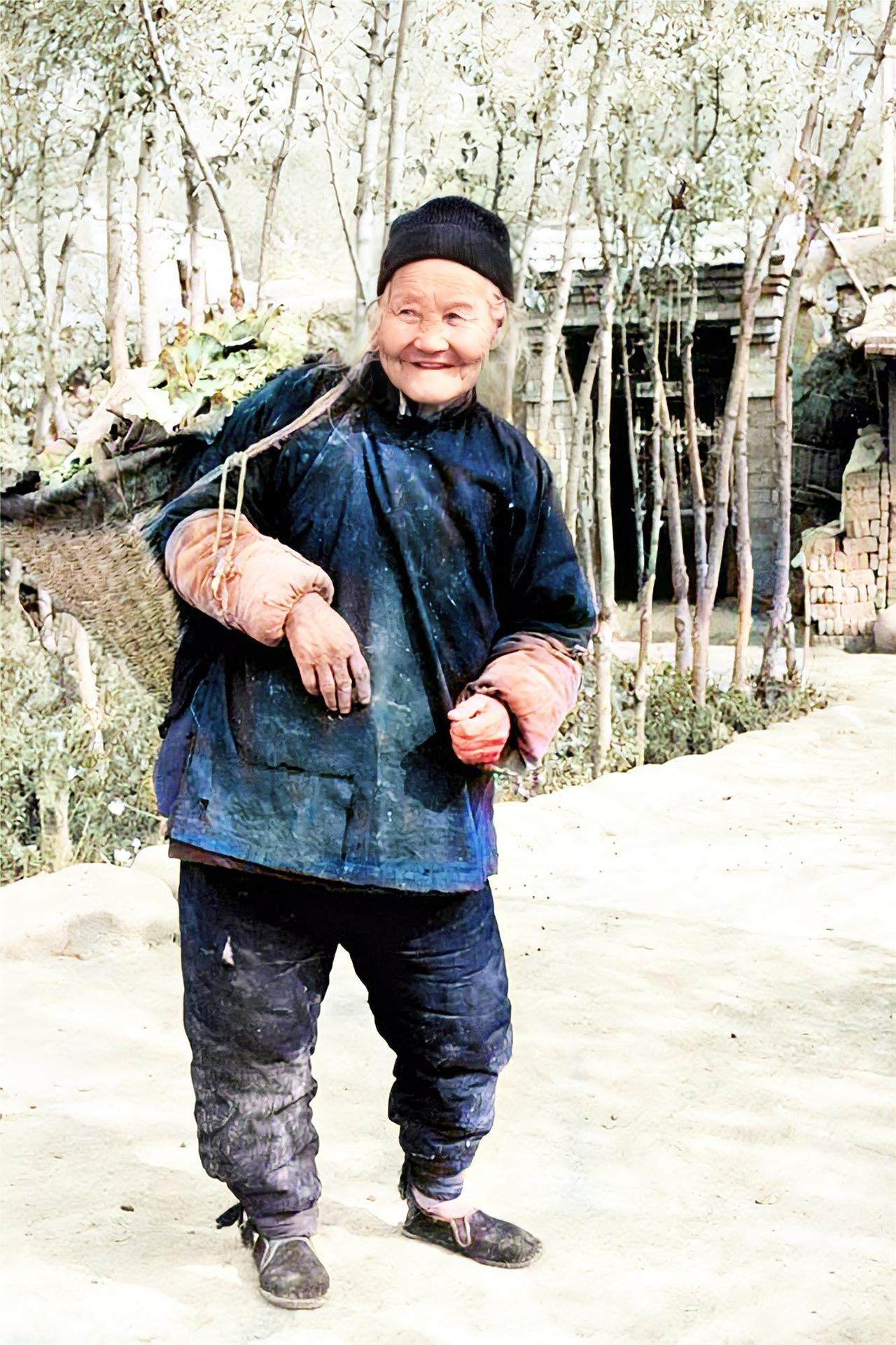 1987年，青海西宁乡村的一个老奶奶，头顶布帽， 穿着厚实偏襟棉衣和扎腿棉裤，戴