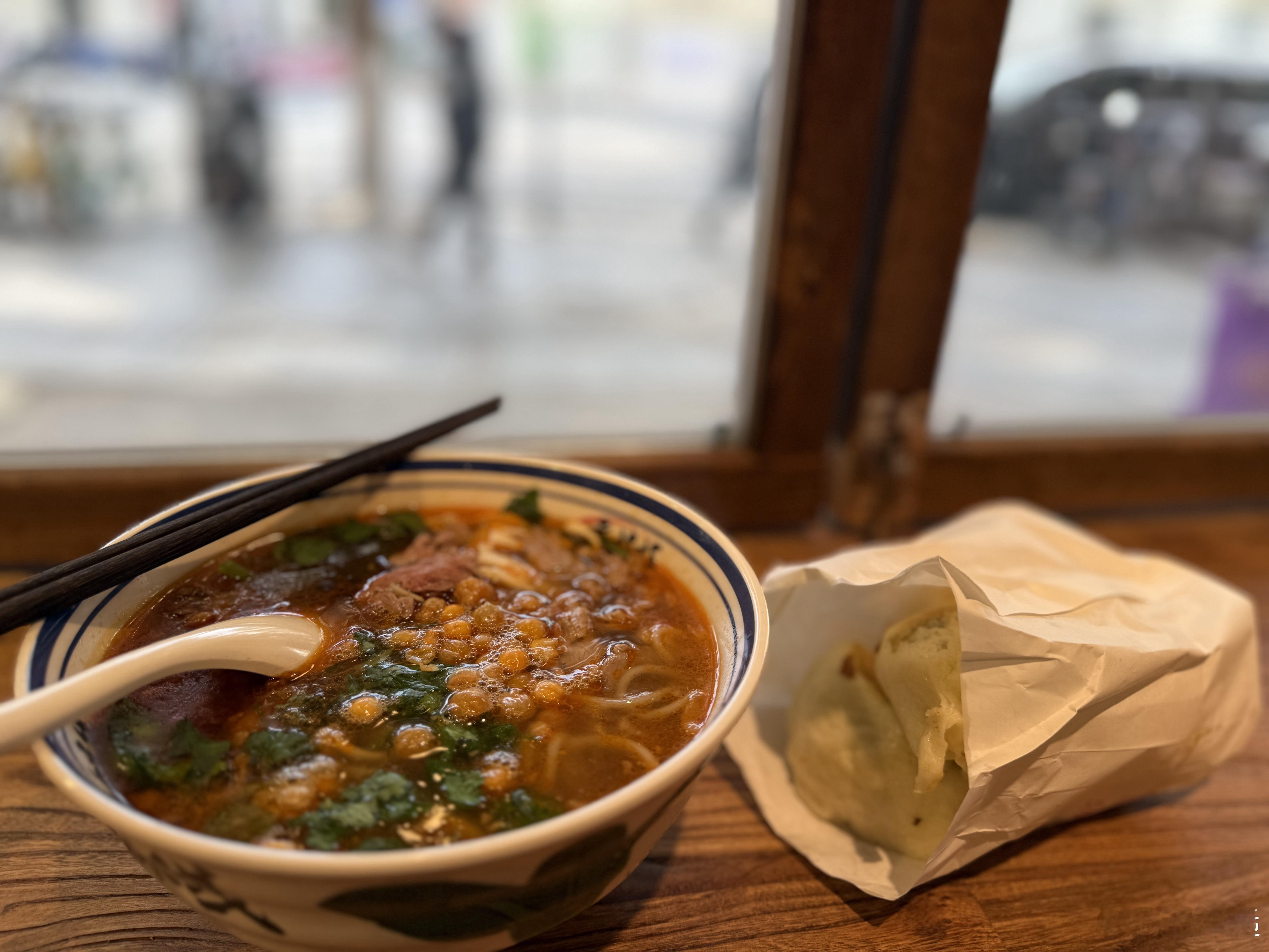 早餐坐在橱窗前吃碗米线。周末加菜，又去连锁快餐店买了四个水煎包，一块钱一个。付款
