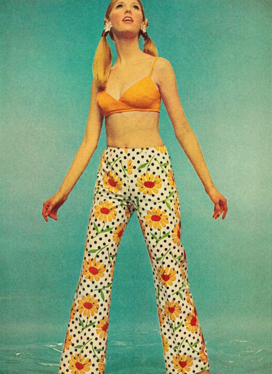 双马尾 + 小雏菊发饰，搭配橘色短吊带和满印雏菊喇叭裤，露腰设计在当年简直是先锋