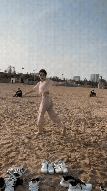 女生在海边沙滩即兴表演侧空翻，第一下腰部力量，身体柔韧性表现得非常好成功作出了漂