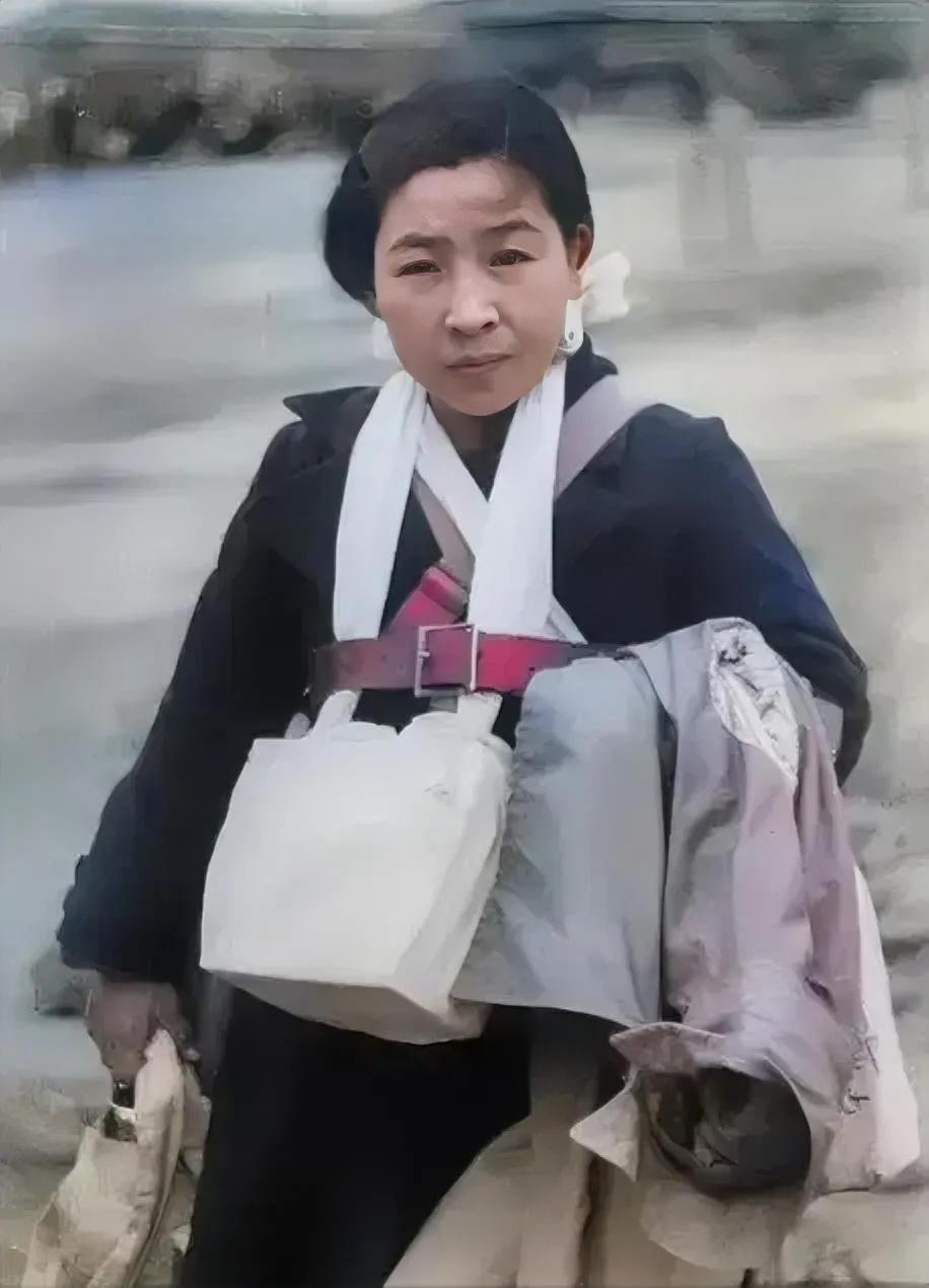 1945年，一名被遣返的日本妇女，这个女人的脖子上挂着丈夫的骨灰，看上去十分愁眉