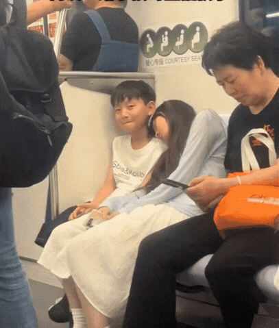 浙江，一妈妈带着儿子乘坐地铁，
不料乘坐途中，儿子旁边的一个
陌生小姐姐却靠在儿