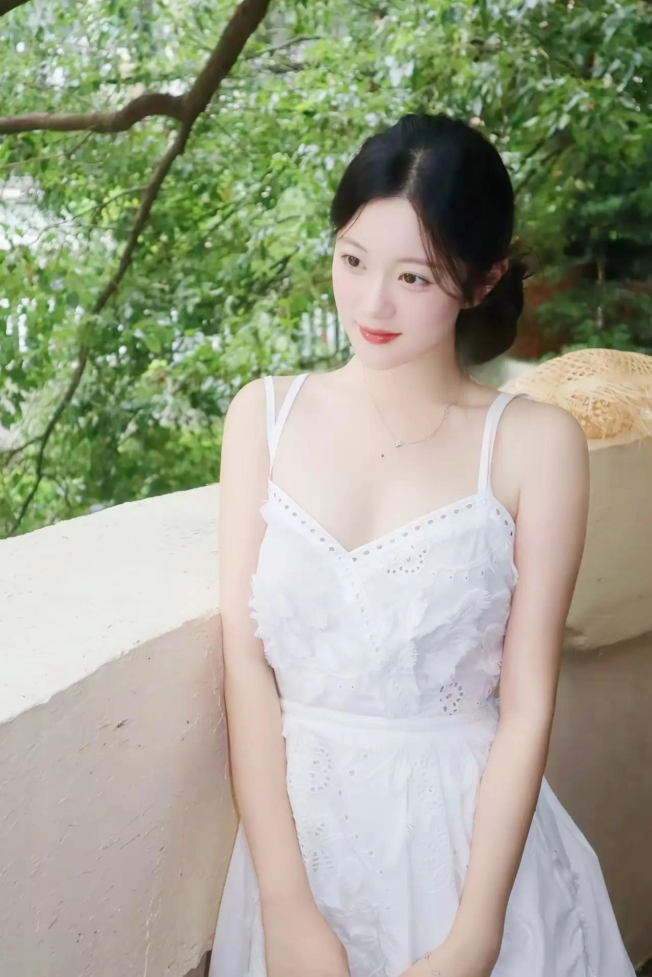 《绿意间的优雅时光》
一袭白色吊带连衣裙，于阳光下泛着柔和的光。那裙子上精致的镂