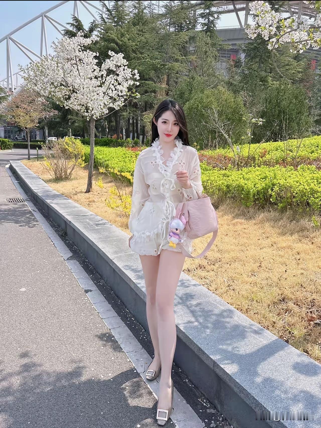 春日穿搭指南：甜美白色连衣裙，搭配粉色包包，漫步在花海中。