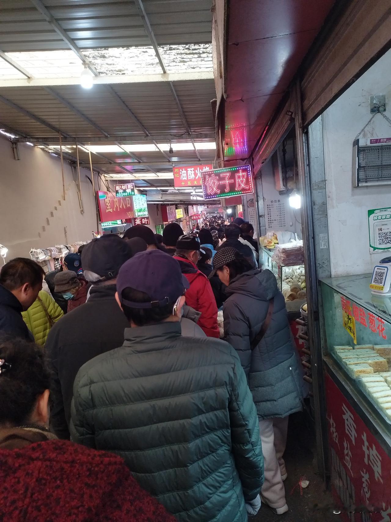 今早去市场，顺便买饺子皮，没想到还要排长队，看来冬至吃饺子深入人心啊。
当前面还