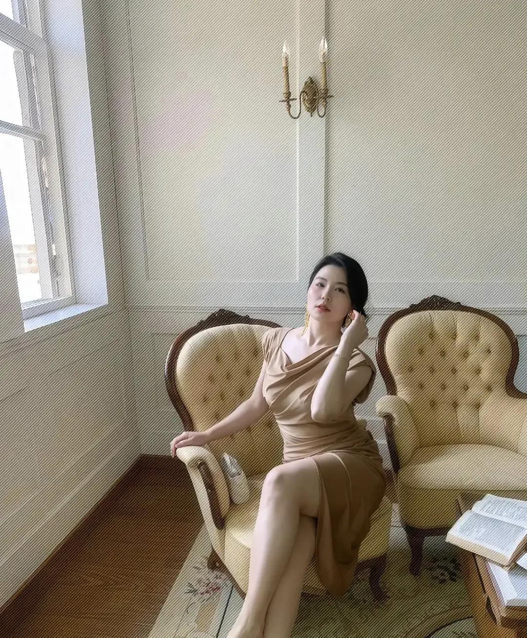 已婚女人，一抬手就赢
 
不是滤镜，是日子把她磨出了光。午后浅驼色裙贴着皮肤，像