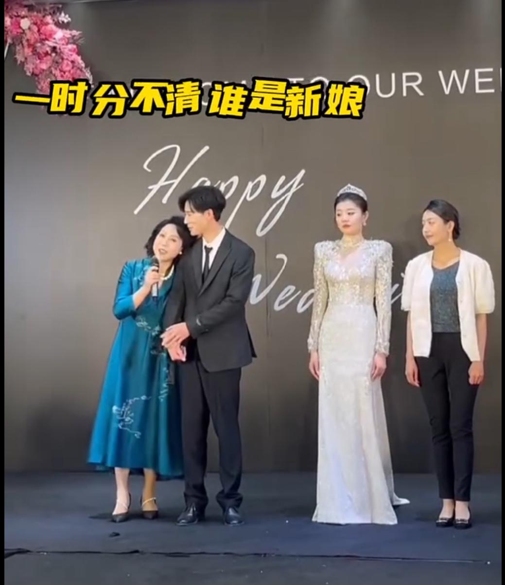 喜婆婆在儿子婚礼上发表讲话，全程依偎在新郎身上，新娘都看愣了。新娘看着母子俩这一